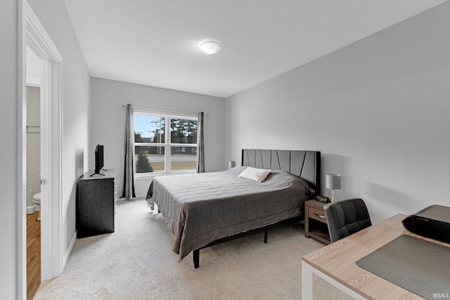 bedroom featuring light colored carpet