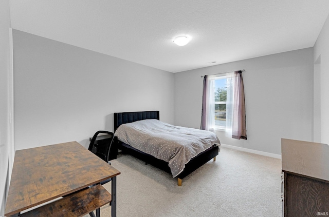 carpeted bedroom featuring baseboards