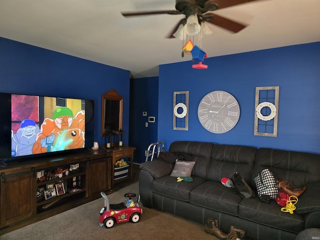 home theater room with carpet floors and a ceiling fan