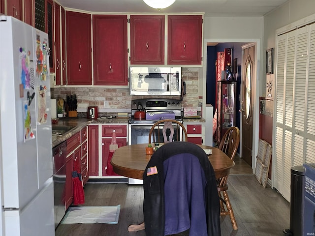 kitchen featuring dark wood-style floors, dark brown cabinets, appliances with stainless steel finishes, and decorative backsplash