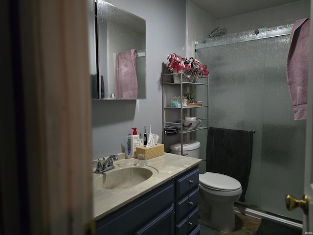 bathroom with vanity, toilet, and an enclosed shower