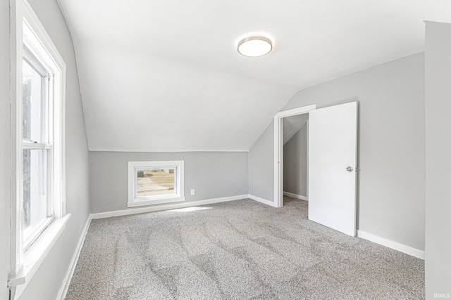 additional living space featuring lofted ceiling, carpet flooring, and baseboards