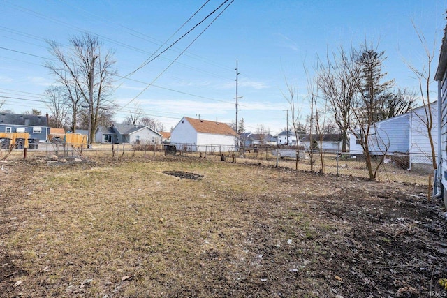 view of yard with a residential view and fence