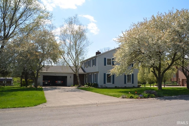 view of front of home with a garage, a chimney, a front lawn, and concrete driveway