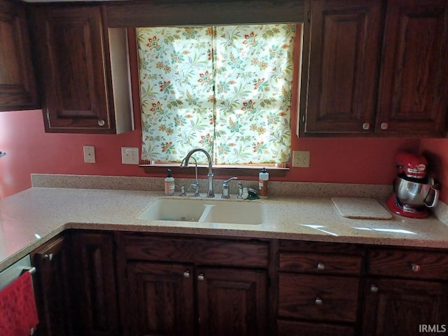 kitchen with light stone countertops and a sink