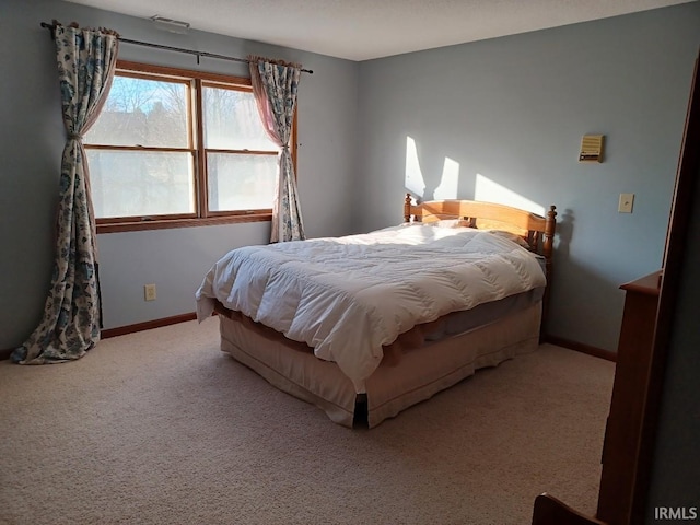 carpeted bedroom with visible vents and baseboards