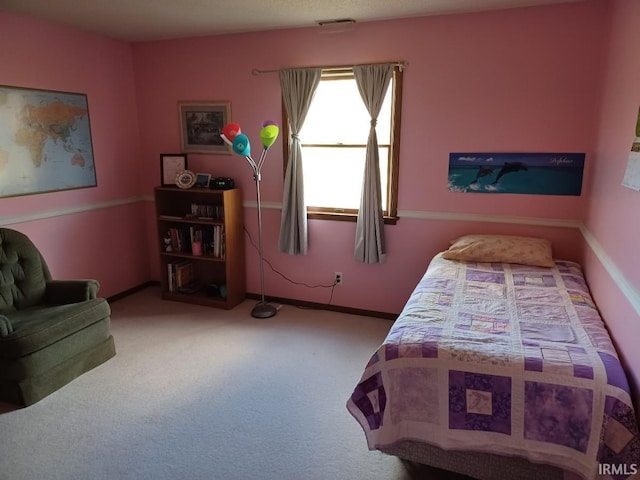 carpeted bedroom featuring baseboards and visible vents