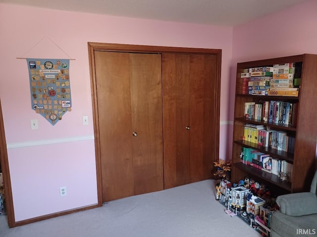 bedroom with carpet and a closet