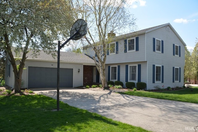 colonial inspired home with concrete driveway, a front lawn, a chimney, and an attached garage