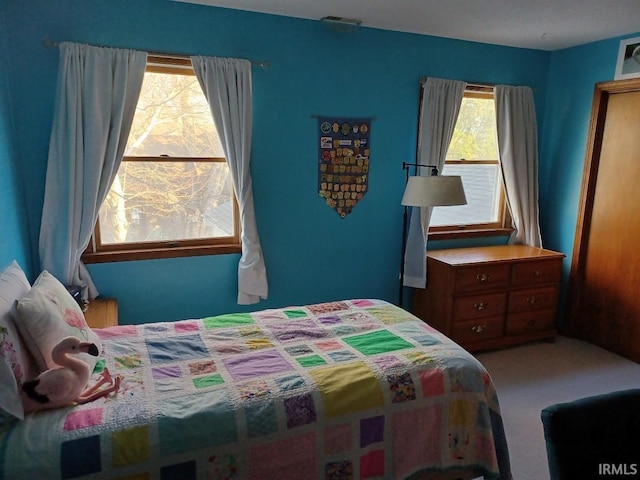 bedroom featuring carpet flooring and visible vents