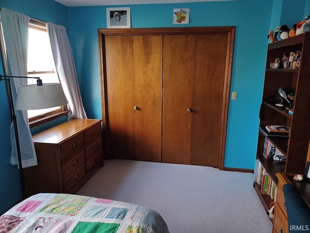 carpeted bedroom featuring a closet