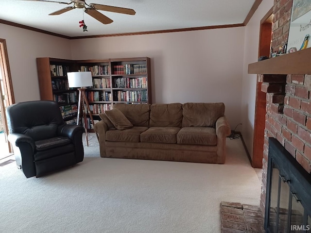 carpeted living area with ceiling fan, a fireplace, and crown molding