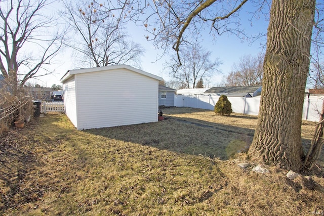 view of yard with a fenced backyard and an outdoor structure