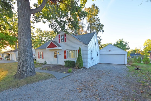 view of front of house featuring a garage, an outbuilding, and roof with shingles