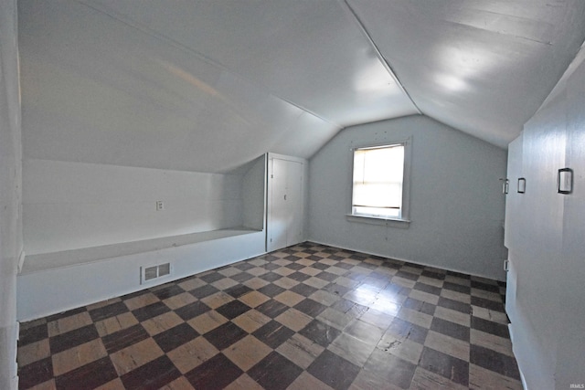 bonus room with lofted ceiling and visible vents