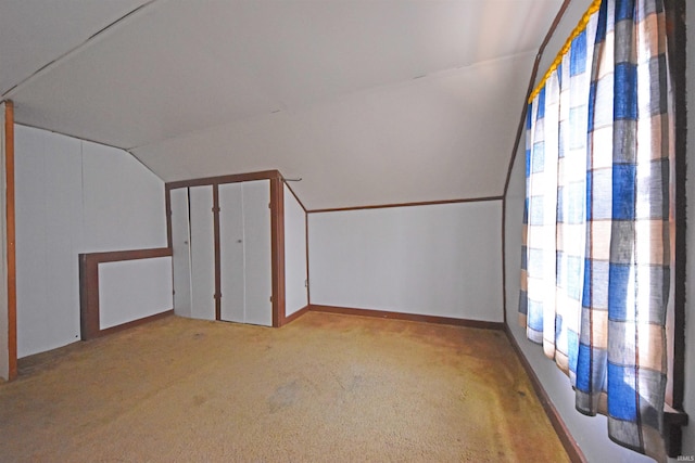 additional living space featuring lofted ceiling, carpet, and baseboards