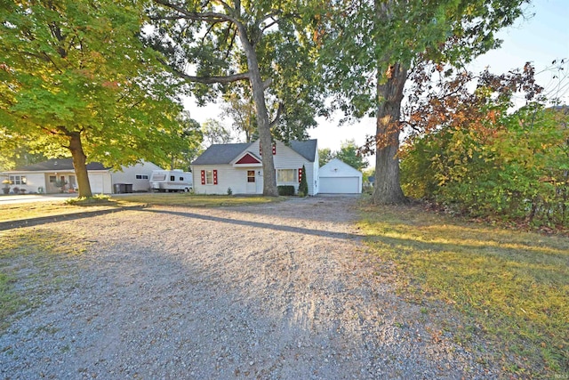 view of front facade featuring a garage and an outdoor structure