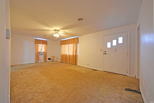 interior space featuring baseboards, carpet, visible vents, and a ceiling fan