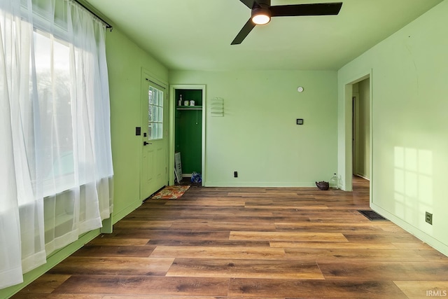 spare room featuring visible vents, ceiling fan, and wood finished floors