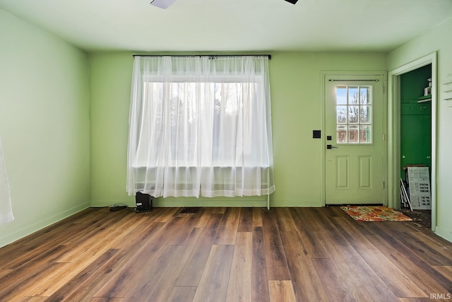 interior space featuring baseboards and wood finished floors