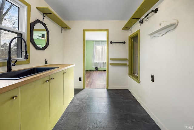 interior space with a sink and baseboards