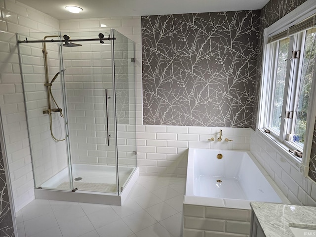 full bath featuring a stall shower, a garden tub, tile walls, and wallpapered walls