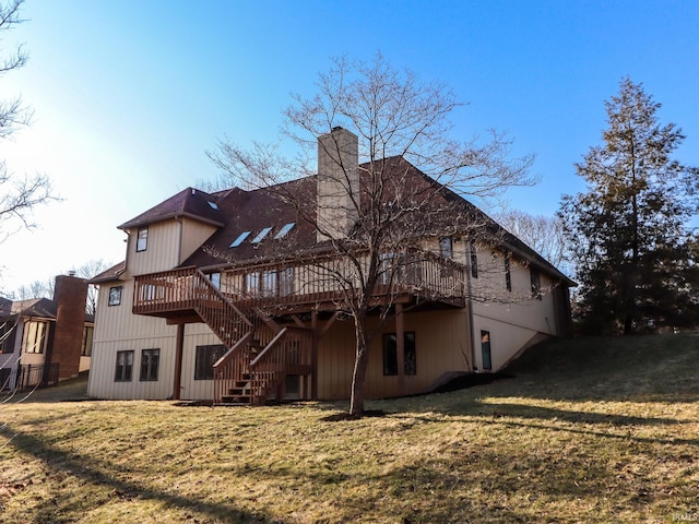 rear view of house featuring stairs, a chimney, a deck, and a yard