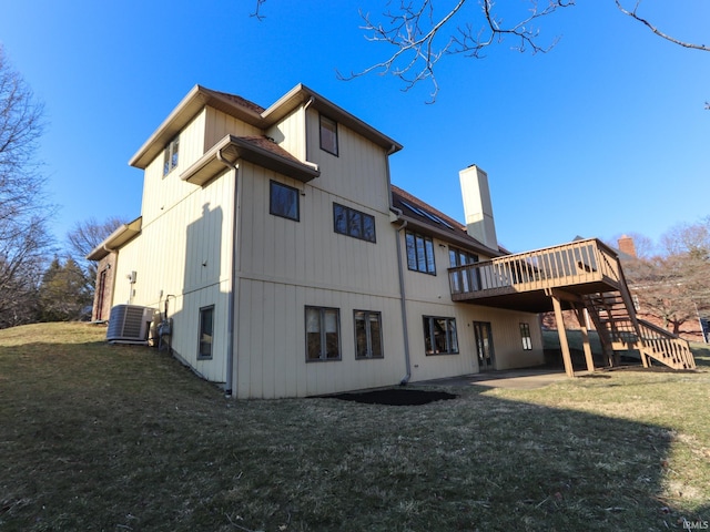 back of property with a lawn, stairway, central AC unit, a patio area, and a deck