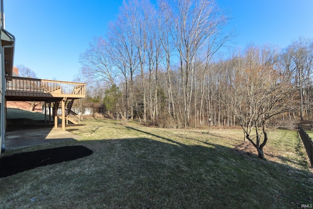 view of yard with a deck and stairs