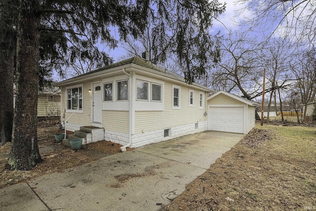 view of front of house with a garage, driveway, an outbuilding, and entry steps