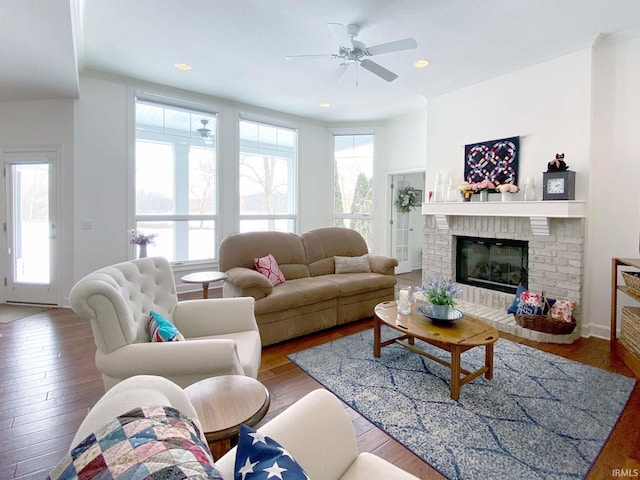 living area with plenty of natural light, a fireplace, and hardwood / wood-style flooring