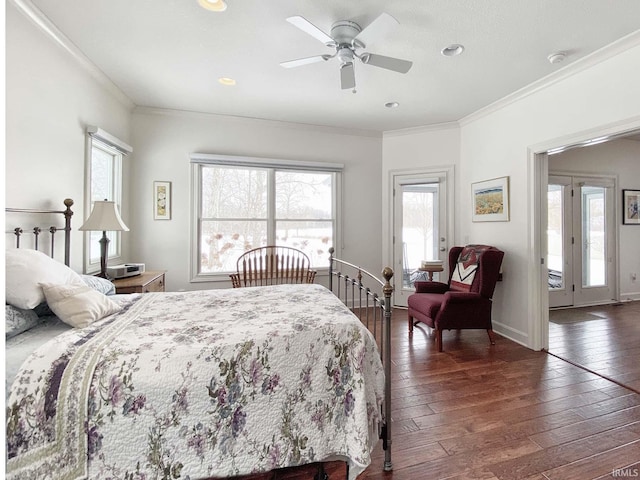 bedroom with ornamental molding, baseboards, hardwood / wood-style floors, and a ceiling fan