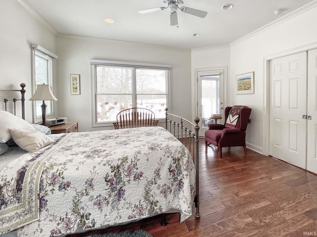 bedroom featuring a ceiling fan, crown molding, baseboards, and hardwood / wood-style floors