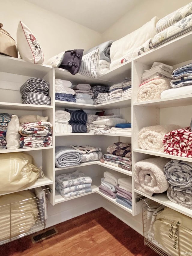 walk in closet featuring wood finished floors and visible vents