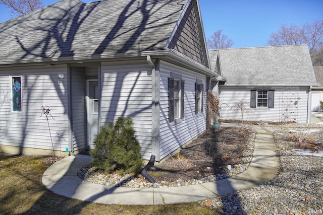 view of home's exterior with roof with shingles