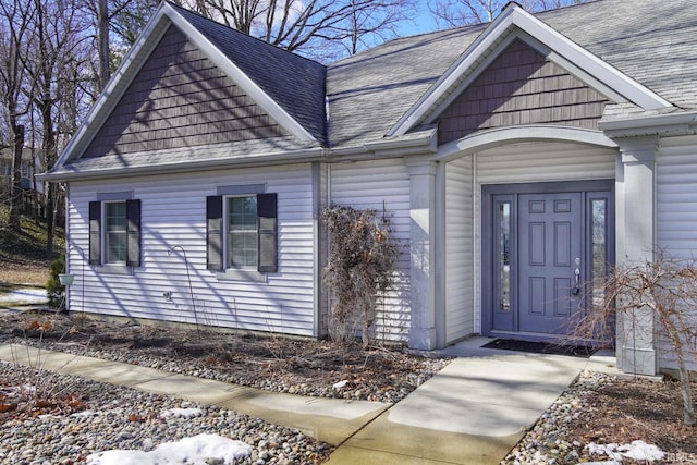 property entrance with roof with shingles