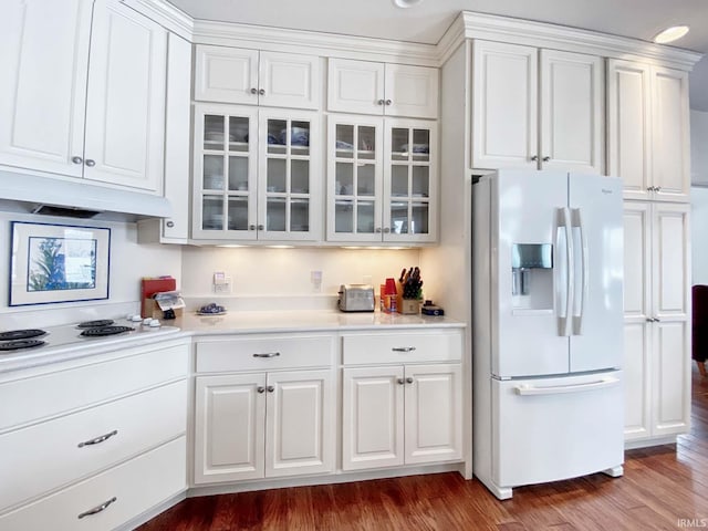 kitchen featuring white appliances, white cabinetry, under cabinet range hood, and wood finished floors