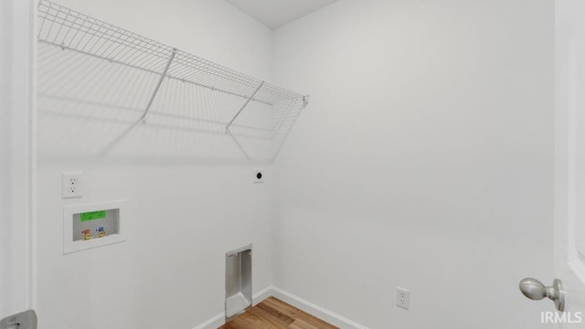 laundry room with hookup for an electric dryer, laundry area, washer hookup, baseboards, and light wood finished floors