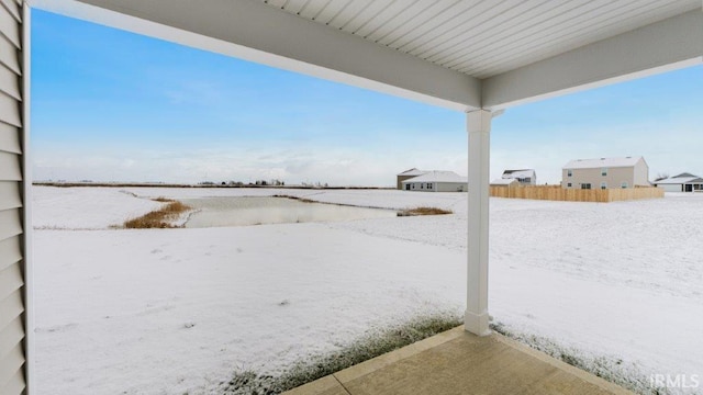 yard covered in snow with fence