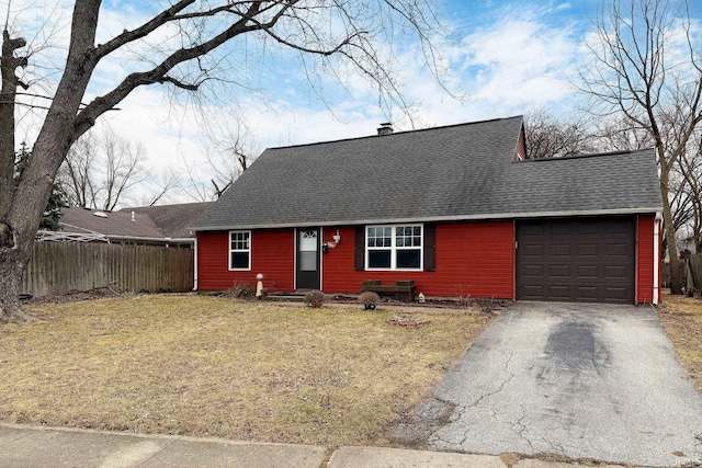 view of front of home with a front yard, fence, roof with shingles, a garage, and aphalt driveway