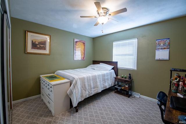 bedroom featuring light carpet, ceiling fan, and baseboards