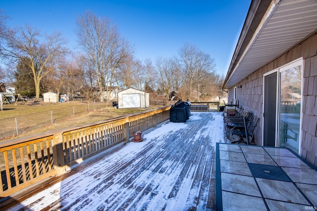 deck featuring an outbuilding and a lawn