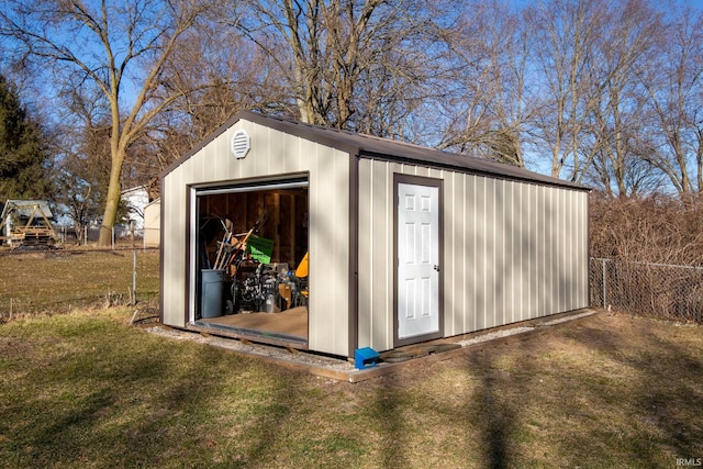 view of outbuilding with an outdoor structure and fence