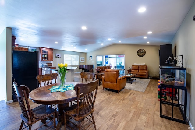 dining room with light wood-type flooring, baseboards, vaulted ceiling, and recessed lighting