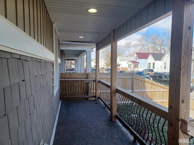 view of patio featuring a residential view and fence