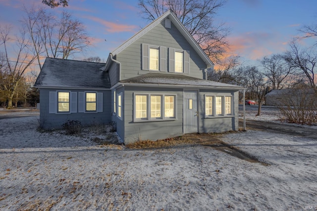 back of property with roof with shingles