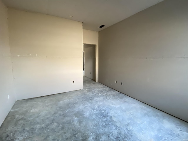 unfurnished room featuring concrete floors