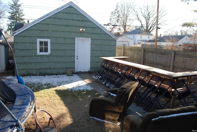 view of outbuilding featuring fence