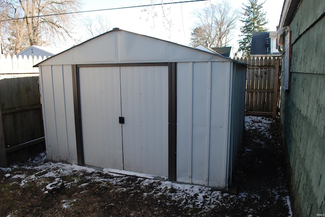 view of shed featuring fence