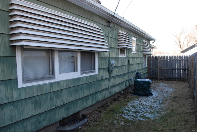 view of side of property featuring fence